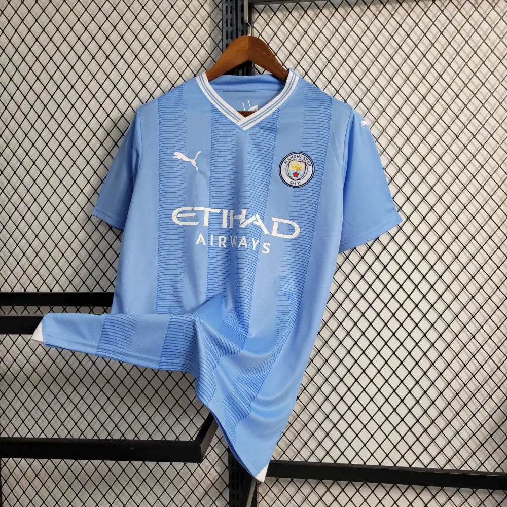 Manchester City 23/24 Home Jersey - Close-up of Manchester City crest and jersey details